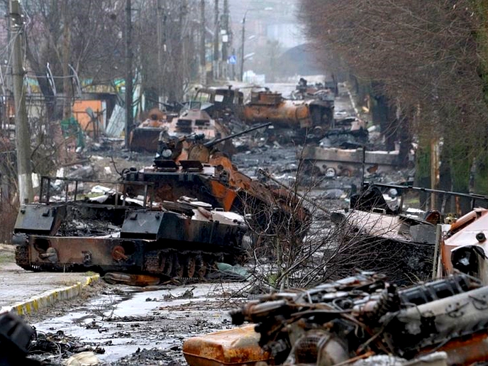 Ukrainian street littered with burned-out tanks and corpses